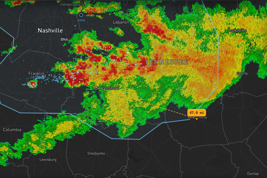 Storm radar with live lightning strikes plotted and a measuring tool showing 47 miles to the nearest cell.